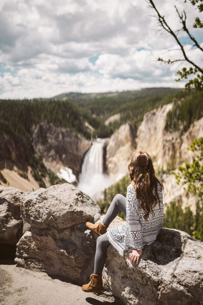 Woman looking at Lower Falls in Yellowstone