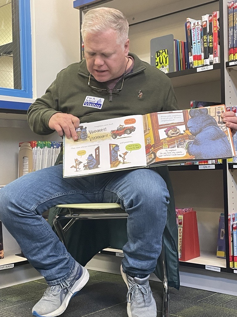 Mac Watson reads to students