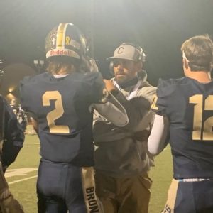 Coach McFadden Center talks with Luke Talich (left) and Caleb Pryor (Right)