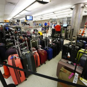 Baggage stacks up from delayed travellers in the baggage claim area in Denver International Airport Wednesday, June 16, 2021, in Denver.  The Biden administration is planning to require that airlines refund fees on checked baggage if the bags get seriously delayed. The proposal would also require refunds for fees on extras like internet access if the airline fails to provide the service during the flight.   (AP Photo/David Zalubowski)