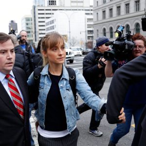 FILE - Allison Mack leaves Federal court in the Brooklyn borough of New York on April 24, 2018. Mack, an actress best known for playing a young Superman's friend, was sentenced to 3 years in prison for role in NXIVM sex-slave case. (AP Photo/Frank Franklin II, File)