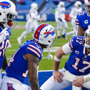 Buffalo Bills' Josh Allen (17) celebrates with teammate Stefon Diggs (14), Dion Dawkins (73), and Zack Moss (20) after connecting with Diggs for a touchdown during the second half of an NFL wild-card playoff football game against the Indianapolis Colts Saturday, Jan. 9, 2021, in Orchard Park, N.Y. (AP Photo/Adrian Kraus)