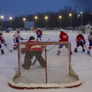 Players take part in the World's Longest Hockey Game near Edmonton on Thursday, Feb. 11, 2021.  Forty players are taking part in the game that will last 252 hours, to raise money for cancer research.  (Jason Franson/The Canadian Press via AP)