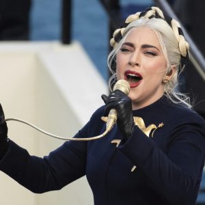 FILE - Lady Gaga sings the national anthem during President-elect Joe Biden's inauguration at the U.S. Capitol in Washington on Jan. 20, 2021. Officials say Lady Gaga’s dog walker was shot and her two French bulldogs stolen in Hollywood during an armed robbery. Los Angeles police are seeking two suspects, thought it’s not known if both were armed, in connection with the Wednesday night shooting. (Saul Loeb(Saul Loeb/Pool Photo via AP, File)