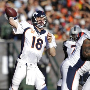 FILE - In this Dec. 29, 2013, file photo, Denver Broncos quarterback Peyton Manning (18) passes against the Oakland Raiders during the second quarter of an NFL football game in Oakland, Calif. With the NFL increasing its season to 17 games for the first change in length of the season since going from 14 to 16 games in 1978, some records and milestones, including Manning's mark of 5,477 yards in the 2013 season could soon be threatened by even more players. (AP Photo/Tony Avelar, File)