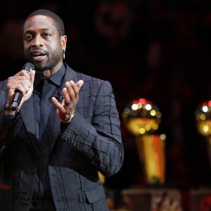 FILE - Former Miami Heat guard Dwyane Wade speaks during a jersey retirement ceremony at halftime of an NBA basketball game between the Heat and the Cleveland Cavaliers in Miami, in this Saturday, Feb. 22, 2020, file photo. Dwyane Wade is an NBA owner. The Utah Jazz announced Friday, April 16, 2021, that the 13-time NBA All-Star will join the youngest ownership group in the league. (AP Photo/Wilfredo Lee, File)