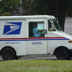 U.S. Postal Service carrier John Graham drives a 28-year-old delivery truck while making's rounds, Wednesday, July 14, 2021, in Portland, Maine. Hundreds of the aging trucks were reported to catch fire in recent years. (AP Photo/Robert F. Bukaty)