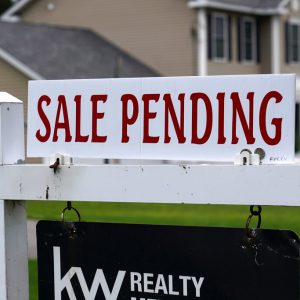 A "sale pending" sign is posted outside a single family home in a residential neighborhood, Wednesday, July 14, 2021, in Derry, N.H. Mortgage rates were mixed this week. The benchmark 30-year loan fell for the third straight week amid lingering concerns over the recent surge in inflation. Mortgage buyer Freddie Mac reports that the average for the 30-year home loan eased to 2.88% from 2.90% last week, down from its peak this year of 3.18% in April.  (AP Photo/Charles Krupa)