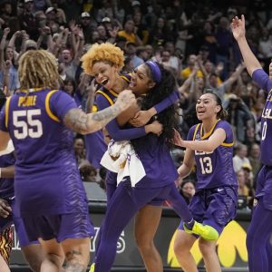 LSU players celebrate a last second shot during the first half of the NCAA Women's Final Four championship basketball game against Iowa Sunday, April 2, 2023, in Dallas. (AP Photo/Darron Cummings)