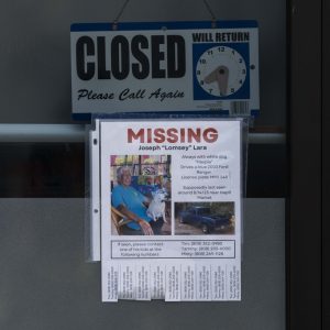 A missing person flyer for Joseph "Lomsey" Lara is posted on the door of a business in a shopping mall in Lahaina, Hawaii, Monday, Aug. 21, 2023. Wildfires devastated parts of the Hawaiian island of Maui earlier this month. (AP Photo/Jae C. Hong)