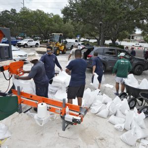Members of the Tampa, Fla., parks and Recreation Dept., help residents with sandbags Monday, Aug. 28, 2023, in Tampa, Fla. Residents along Florida's gulf coast are making preparations for the effects of Tropical Storm Idalia. (AP Photo/Chris O'Meara)