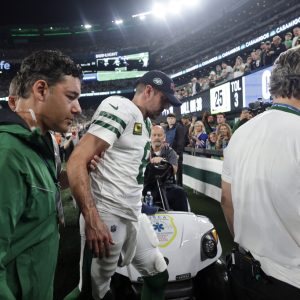 FILE - New York Jets quarterback Aaron Rodgers (8) is helped off the field after getting injured during the first quarter of an NFL football game against the Buffalo Bills, Monday, Sept. 11, 2023, in East Rutherford, N.J. Rodgers has a torn left Achilles tendon and the 39-year-old New York Jets quarterback will miss the rest of the season, coach Robert Saleh announced Tuesday. (AP Photo/Adam Hunger, File)