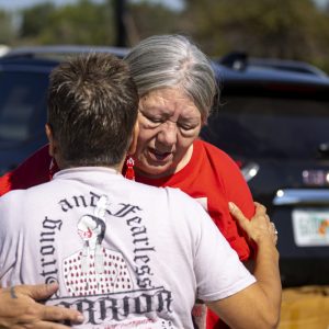 Yolanda Fraser, Kaysera Stops Pretty Places' grandmother, gets a hug before a dedication ceremony for a billboard in support of the Missing and Murdered Indigenous People movement on Tuesday, Aug. 29, 2023, along I-90 in Hardin, Mont. (AP Photo/Mike Clark)