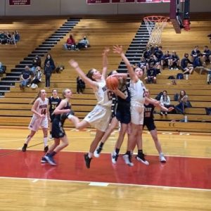 Kennedi Niemann Takes on Two Riverton Defenders in the Fillies 52-19 Quad win