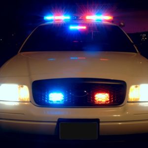 Police_car_with_emergency_lights_on-803x534