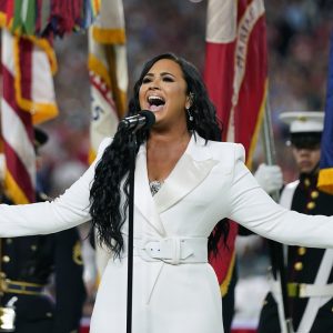 FILE - Demi Lovato performs the national anthem before the NFL Super Bowl 54 football game between the San Francisco 49ers and the Kansas City Chiefs in Miami Gardens, Fla., on Feb. 2, 2020. Lovato reveals publicly for the first time details about her near-fatal drug overdose in 2018 in “Demi Lovato: Dancing With the Devil,” a four-part docuseries debuting March 23, 2021, on YouTube Originals. (AP Photo/David J. Phillip, File)